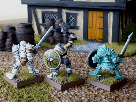 Back view of three Slaaneshi Warriors of Chaos advancing on a house