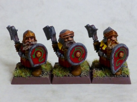 Three dwarf troopers of the Dragon Company with axes and shields
