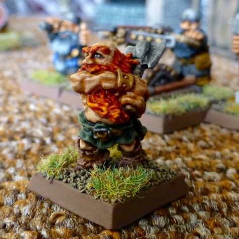 Orange haired Dwarf swinging an axe with both hands