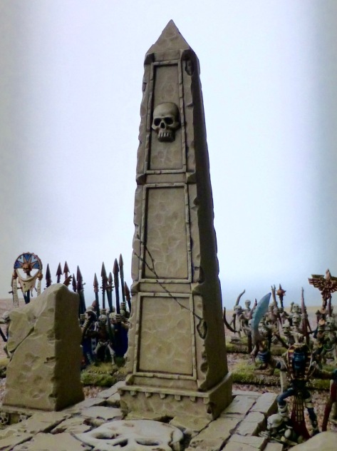 Sandstone obelisk adorned with a skull