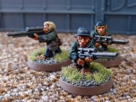 Another group of three Halfling models with rifles wearing green uniform jackets