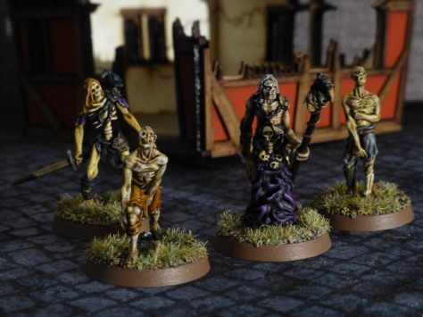 A necromancer flanked by three zombies