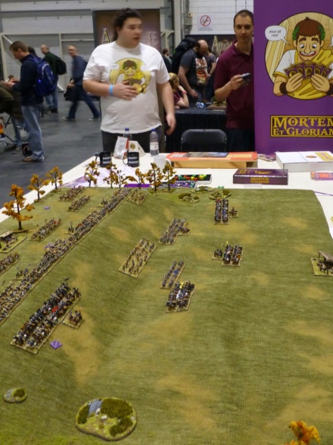 Wargames table with ranks of small scale miniatures