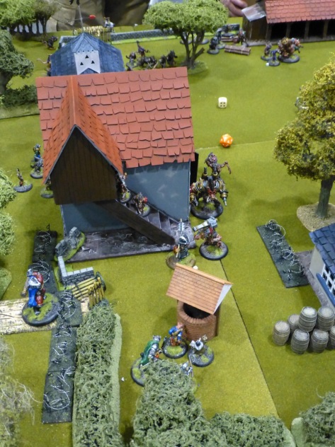 Farmland and buildings with skirmishing miniatures