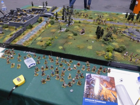 Large wargames table with grassland, river and ruins