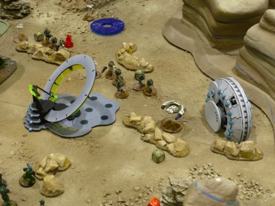 Futuristic generators in a desert with infantry and drones