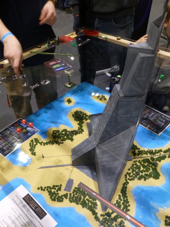 A tower rising up from a small island, surrounded by space fighter craft