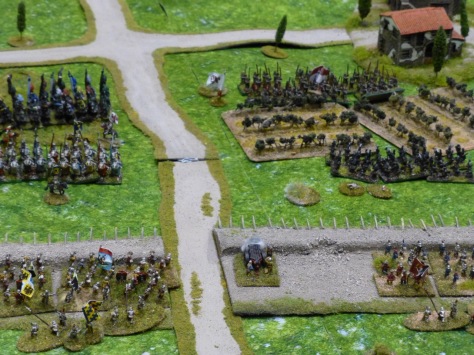 Troops behind defensive earthworks waiting for an attack through a vineyard