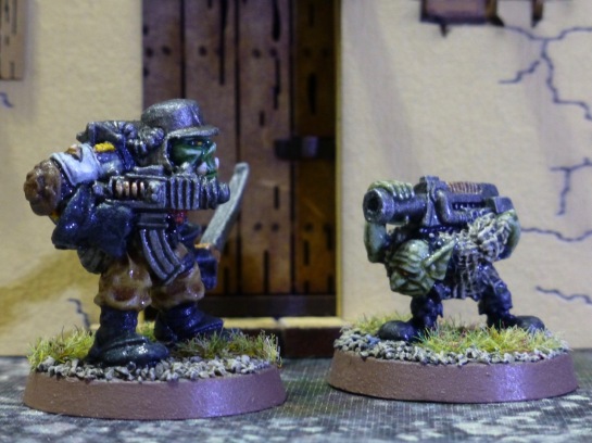 Space Ork with steel helmet and boltgun next to a Gretchin carrying a large boltgun on his back