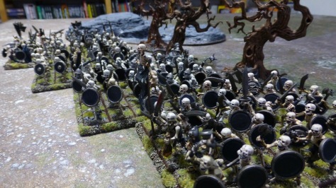 Line of skeletal warriors advancing across rough ground