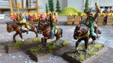 Three colourfully dressed horse archers