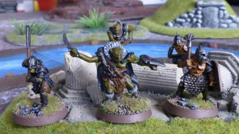 Group of five orcs amongst broken pillars with a river in the background