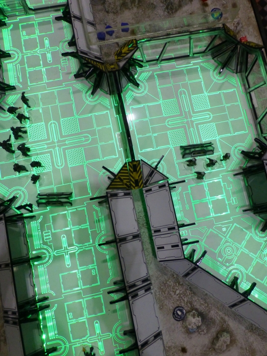 Top down view of a green illuminated floor reminiscent of computer circuits