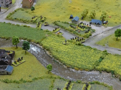 A river running through fields with farmsteads occupied by soldiers