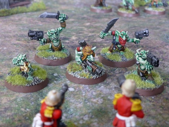 Five Gretchin attack soldiers of the Imperial Guard